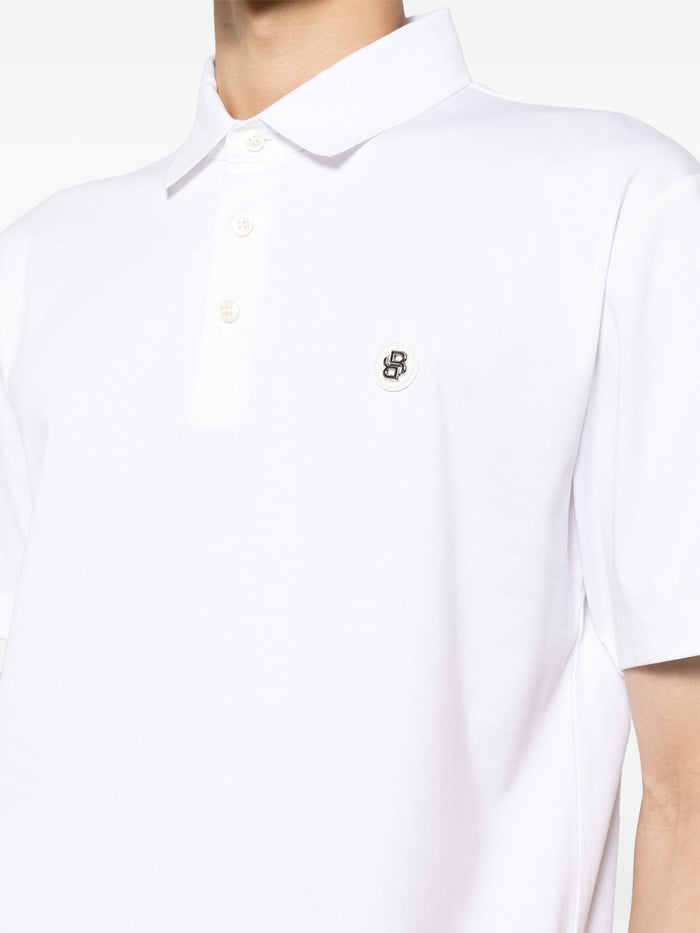 Close-up of the logo patch on the BOSS Cotton Polo Shirt in White, emphasizing its iconic branding.