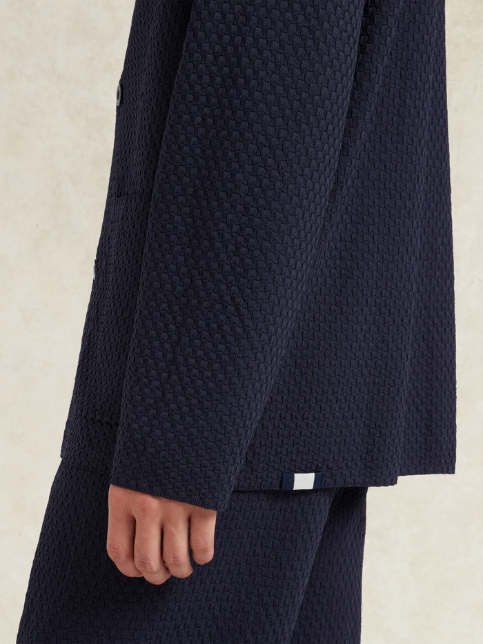 CHÉ Garcia Knitted Blazer Navy - Side profile highlighting the blazer's elegant cut and premium knitted fabric texture