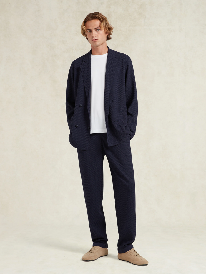 CHÉ Garcia Navy Knitted Trousers - back view displaying the trousers' silhouette and knitted fabric construction
