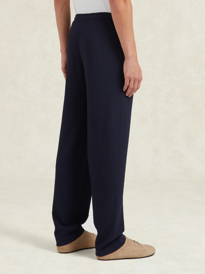 CHÉ Garcia Knitted Trousers Navy - side profile view showing the trousers' fit and knitted texture detail