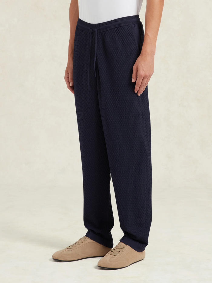 CHÉ Garcia Navy Knitted Trousers - close-up detail of knitted fabric texture and premium craftsmanship