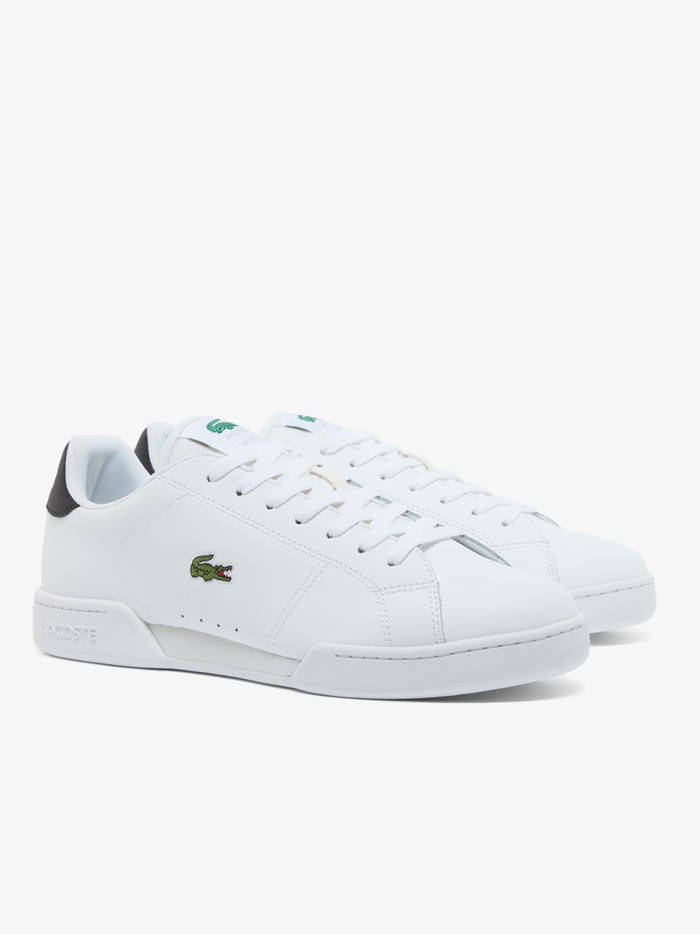 Close-up of LACOSTE Carnaby Cup white leather sneaker heel with embossed LACOSTE branding and green accent detail