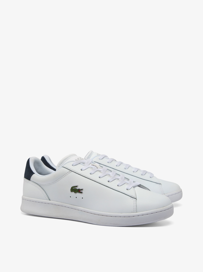 White LACOSTE Carnaby Set leather trainers featuring embroidered green crocodile branding and navy accents