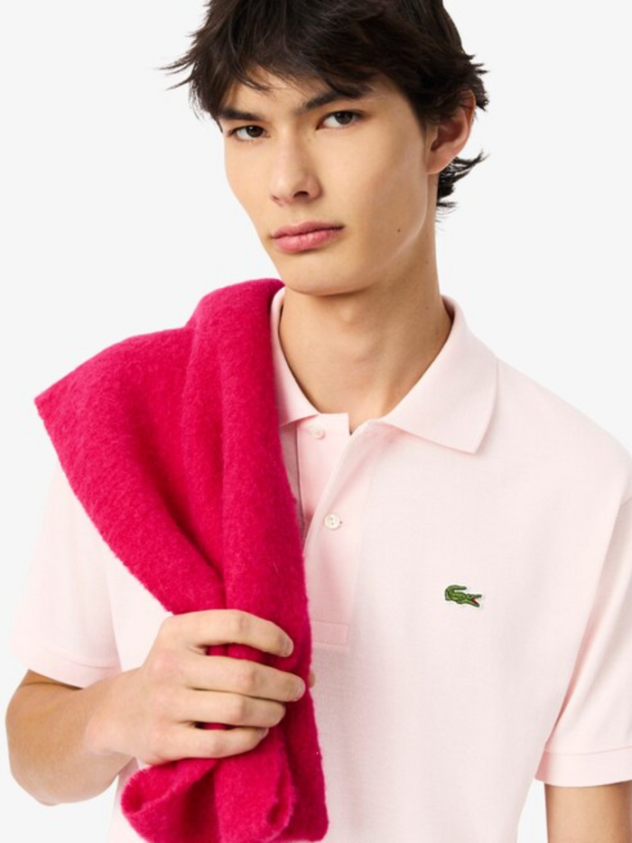 Close-up detail of LACOSTE Light Pink polo shirt showing piqué cotton texture and quality construction