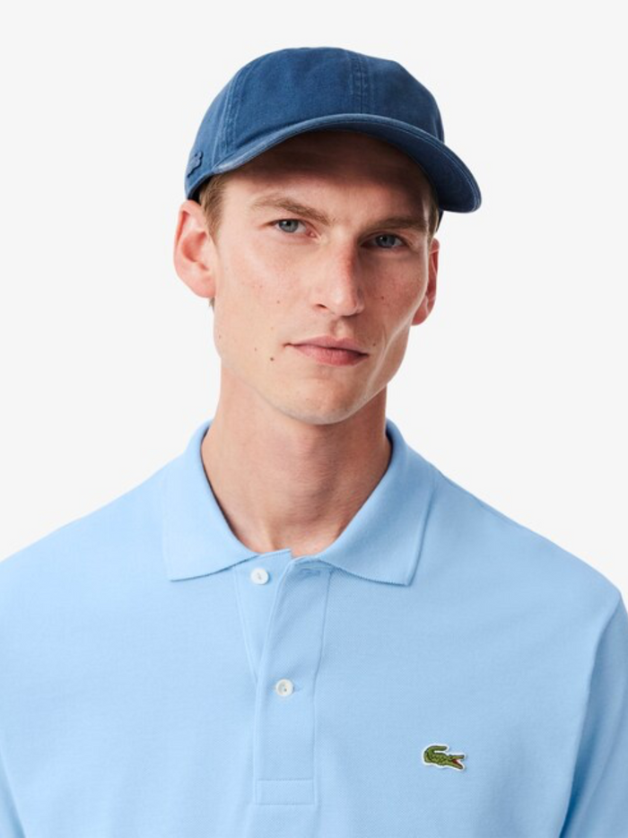 Close-up detail of LACOSTE Pale Blue polo shirt showing piqué cotton texture and quality construction