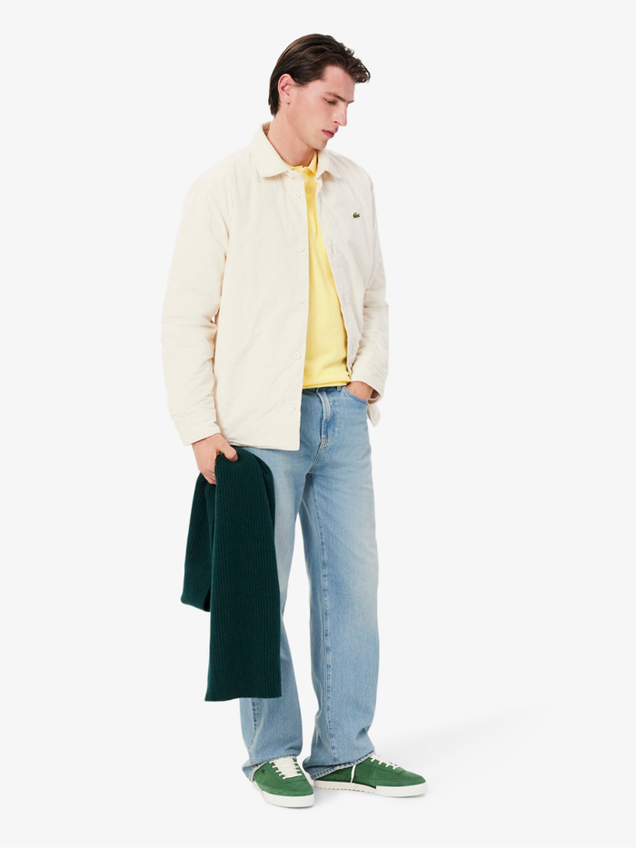 LACOSTE Classic Fit L.12.12 Original Polo Shirt in Pastel Yellow - Side Profile Displaying Ribbed Collar and Sleeve Hems