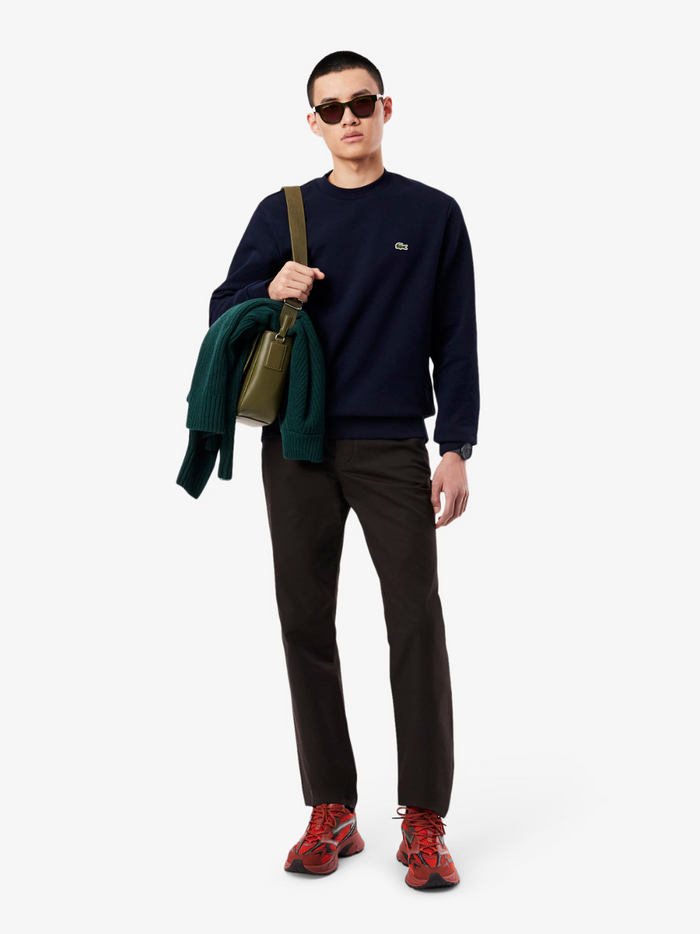 LACOSTE fleece crew neck sweatshirt in Midnight Blue - side profile view showing relaxed silhouette and sleeve detail