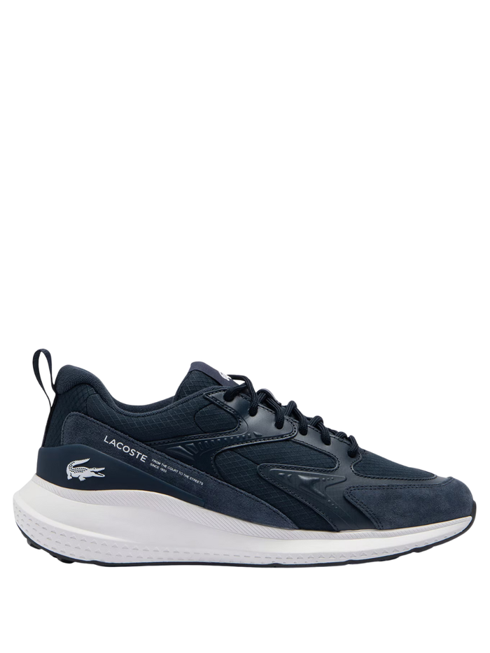 LACOSTE L003 Evo men's sneakers in navy blue and white with mesh panels, green crocodile logo, and chunky white sole, side view