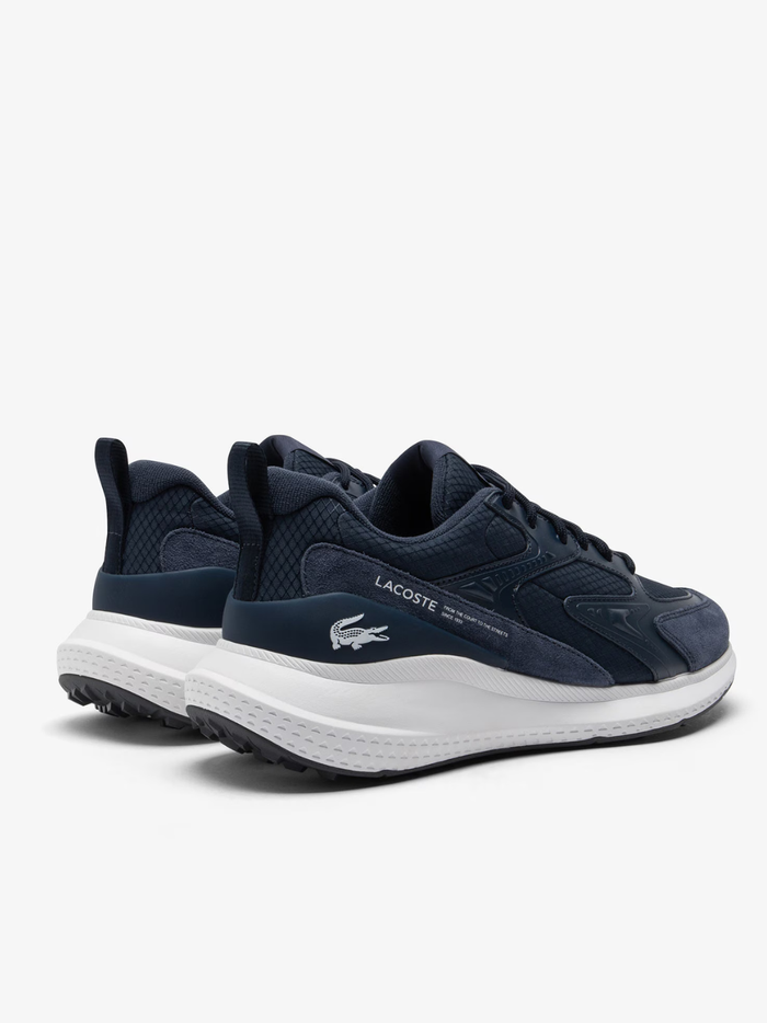 Overhead view of LACOSTE L003 Evo navy and white trainers featuring breathable mesh construction, tonal laces, and embroidered green crocodile logo