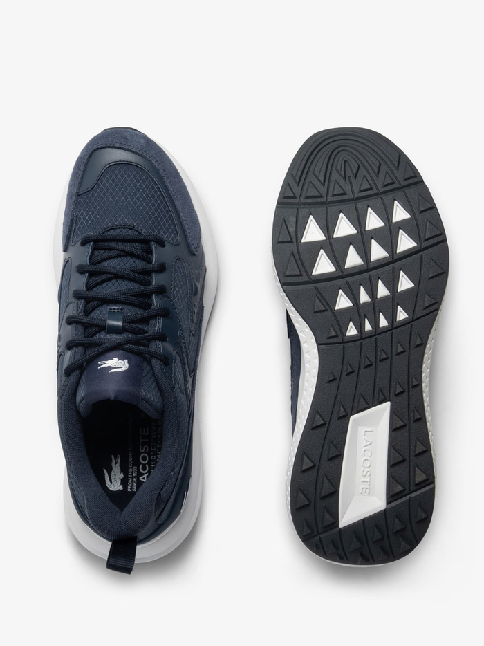 Outsole view of LACOSTE L003 Evo sneakers showing white rubber sole with multi-directional tread pattern and LACOSTE branding