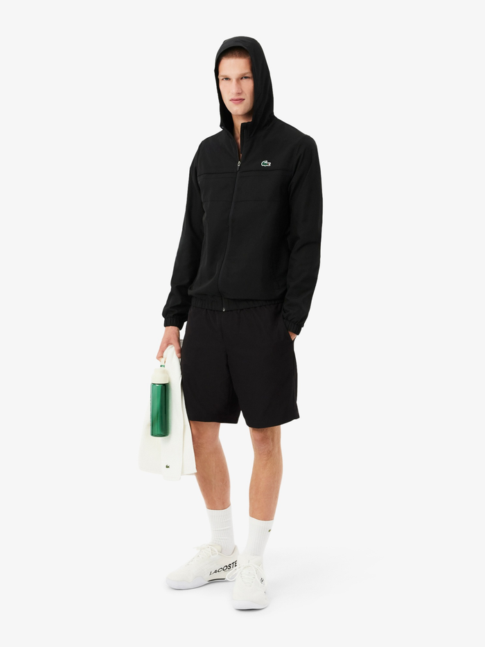 Side view of LACOSTE men's black diamond taffeta shorts with side pockets and athletic fit