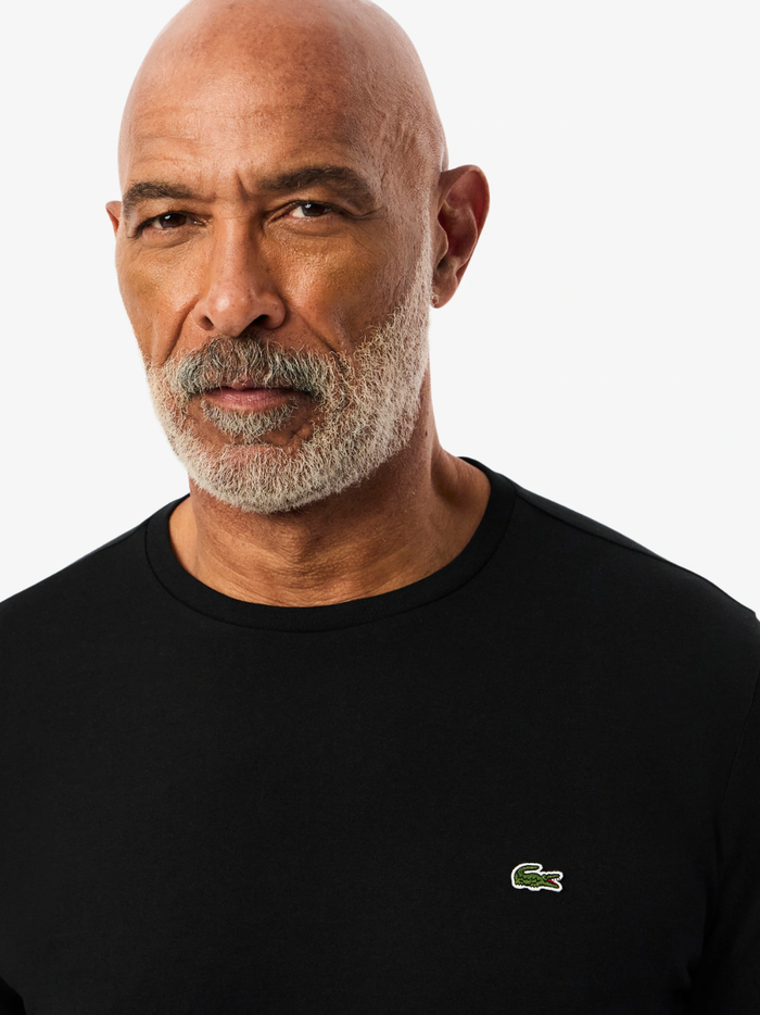 LACOSTE Long Sleeved Cotton Pima T-shirt in Black - detail shot of the signature LACOSTE crocodile emblem