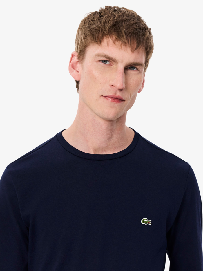 LACOSTE Long Sleeved Cotton Pima T-shirt in Midnight Blue - detail shot of the signature LACOSTE crocodile emblem