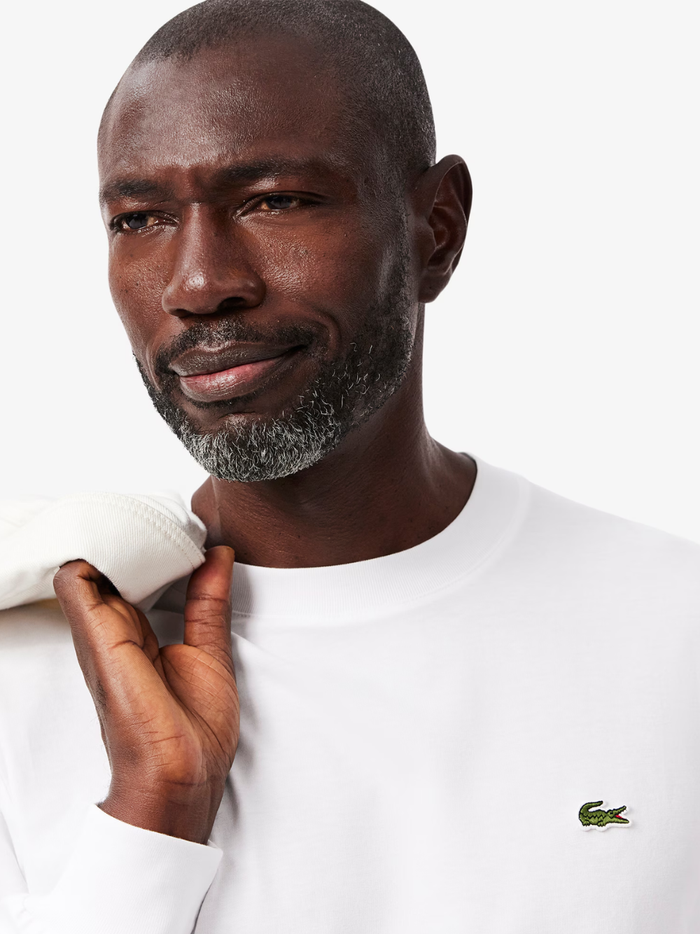 LACOSTE Long Sleeved Cotton T-shirt in White - detail shot of the signature LACOSTE crocodile emblem