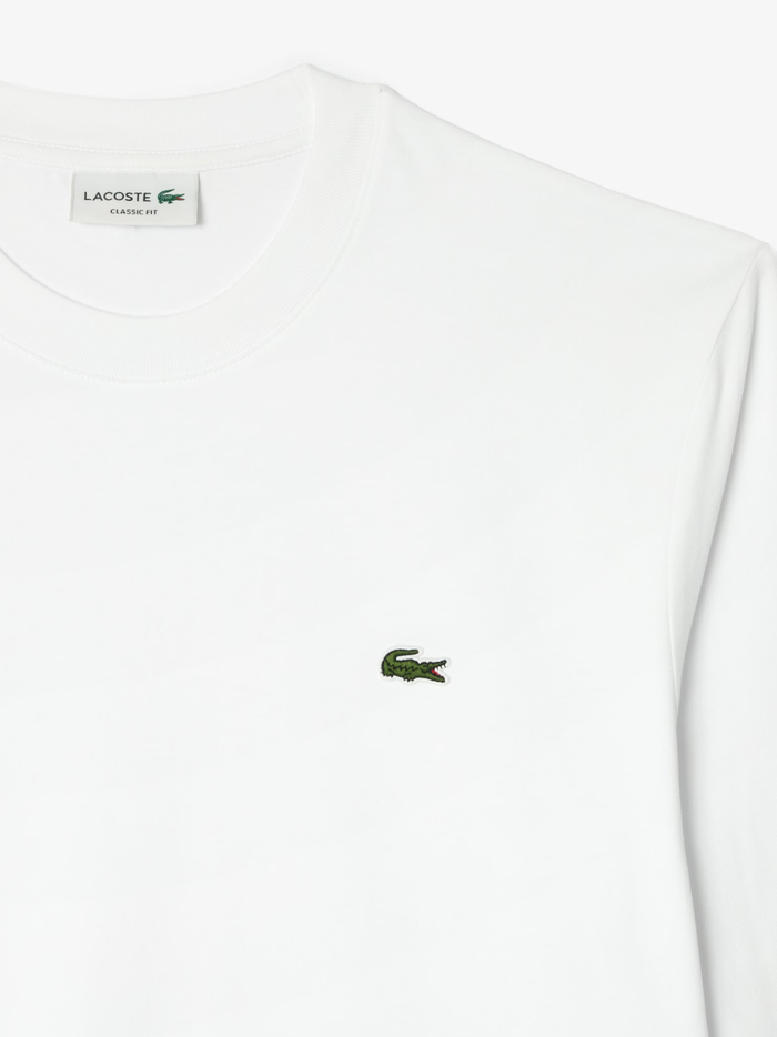 LACOSTE Long Sleeved Cotton T-shirt in White - lifestyle shot showing the versatile styling and fit