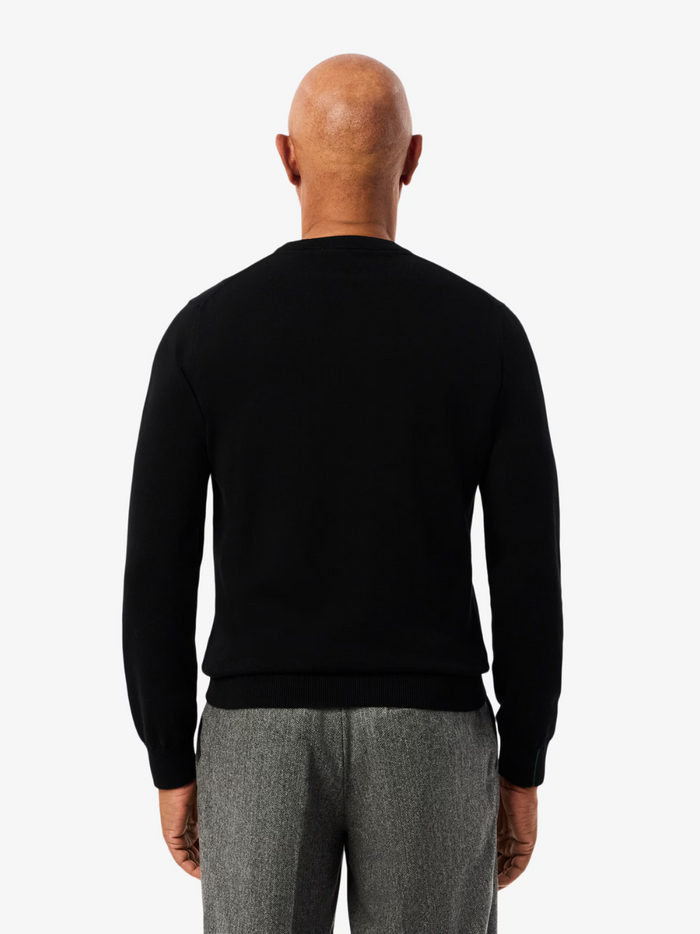 LACOSTE black crew neck sweater lifestyle shot demonstrating versatile styling and comfortable fit