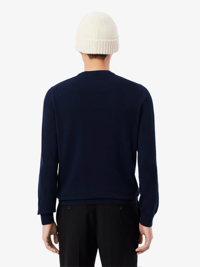 LACOSTE midnight blue crew neck sweater lifestyle shot demonstrating versatile styling and comfortable fit