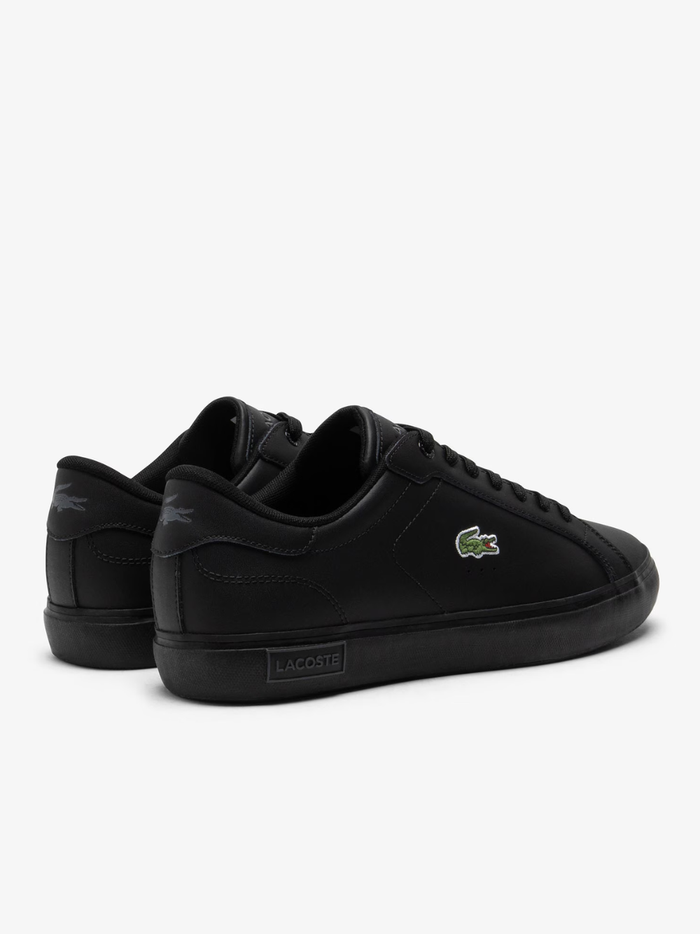Overhead view of LACOSTE Powercourt black leather trainers featuring tonal laces, perforated side panels, and embroidered green crocodile logo