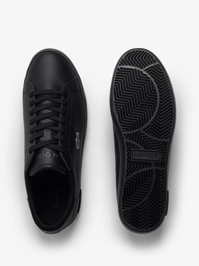 Outsole view of LACOSTE Powercourt sneakers displaying white rubber sole with textured grip pattern and LACOSTE branding
