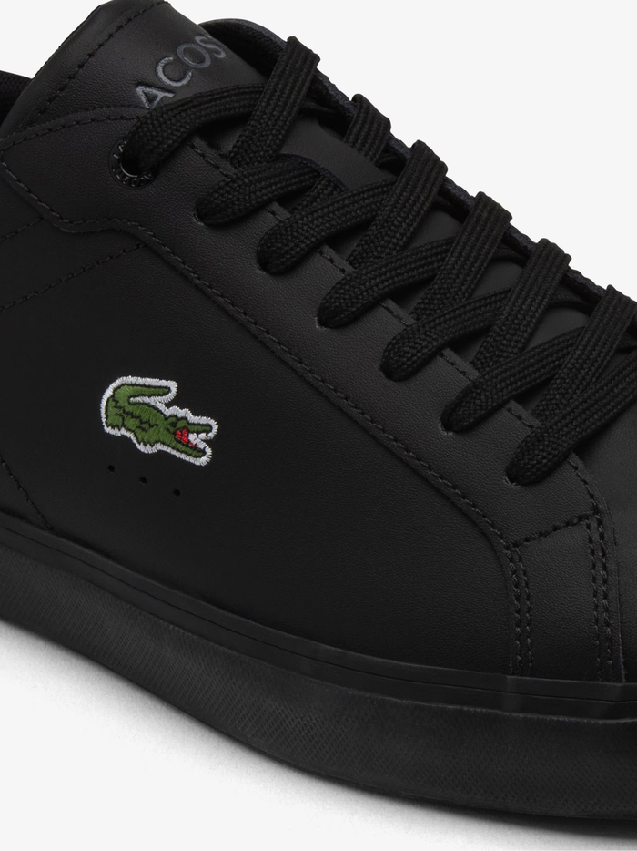 Front view of LACOSTE Powercourt black leather sneakers showing rounded toe box, perforated detailing, and clean minimalist design