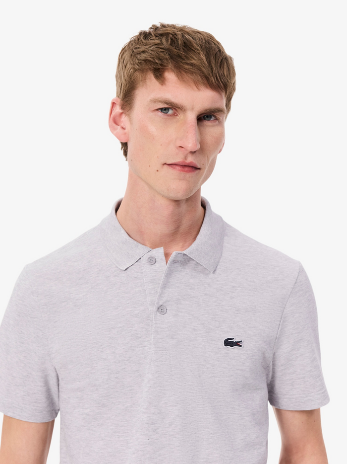 LACOSTE Grey Regular Fit Polo - Close-up detail of embroidered crocodile logo and polo collar construction