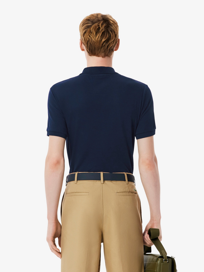 LACOSTE Regular Fit Cotton Pima Polo Shirt collar and chest detail featuring the iconic LACOSTE crocodile logo on midnight blue Pima cotton