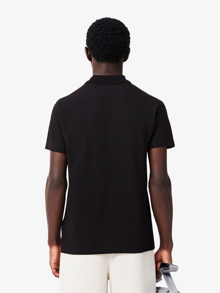 LACOSTE Polo Shirt - Detail shot of signature crocodile logo embroidered on black cotton polyester blend fabric