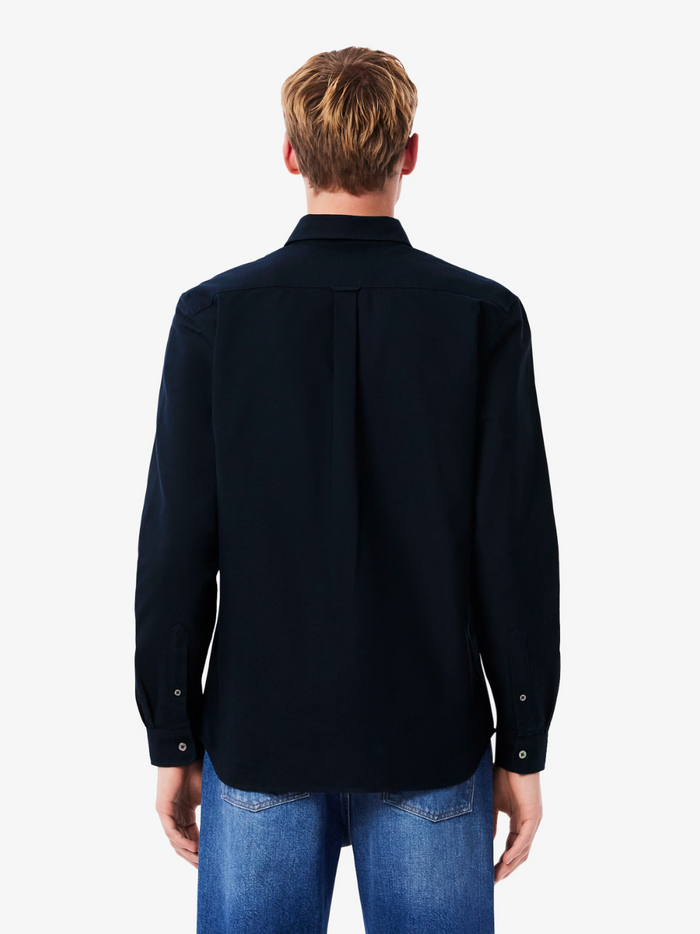 LACOSTE Regular Fit Oxford Shirt collar and chest detail featuring the iconic LACOSTE crocodile logo on navy blue Oxford cotton