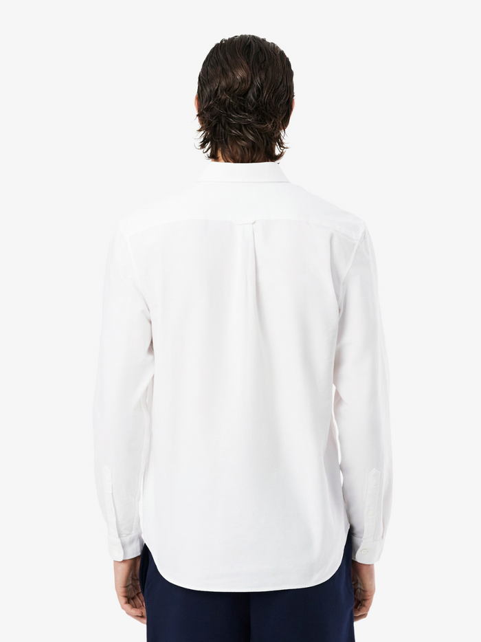 LACOSTE Regular Fit Oxford Shirt collar and chest detail featuring the iconic LACOSTE crocodile logo on white Oxford cotton