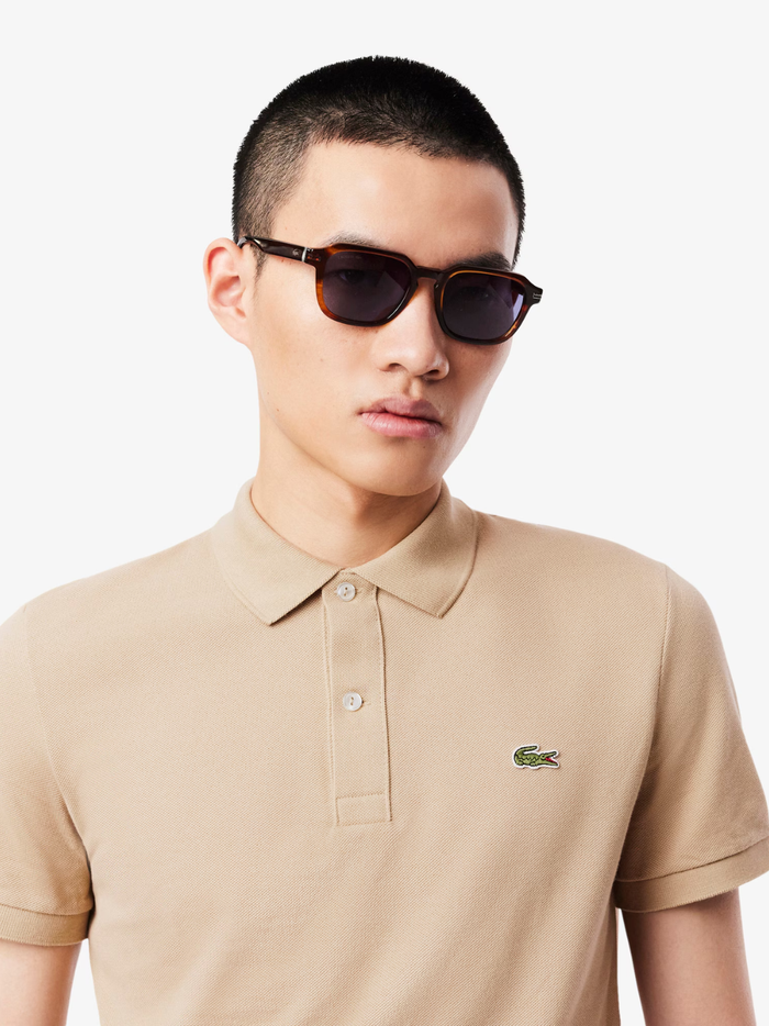 Side profile of LACOSTE L.12.12 beige polo shirt highlighting slim fit cut and ribbed collar detail