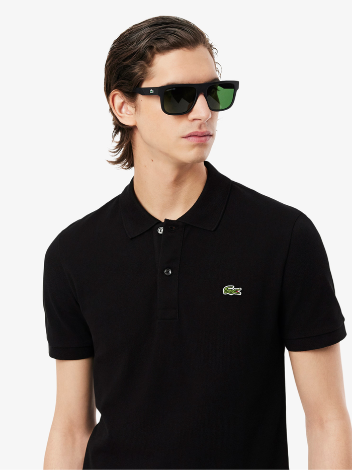 Side profile of LACOSTE L.12.12 black polo shirt highlighting slim fit cut and ribbed collar detail