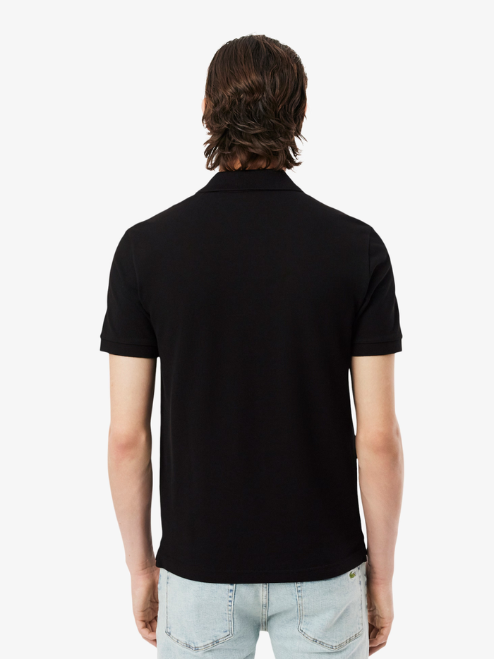 Close-up of LACOSTE polo shirt ribbed collar, mother-of-pearl buttons, and premium piqué fabric weave in black