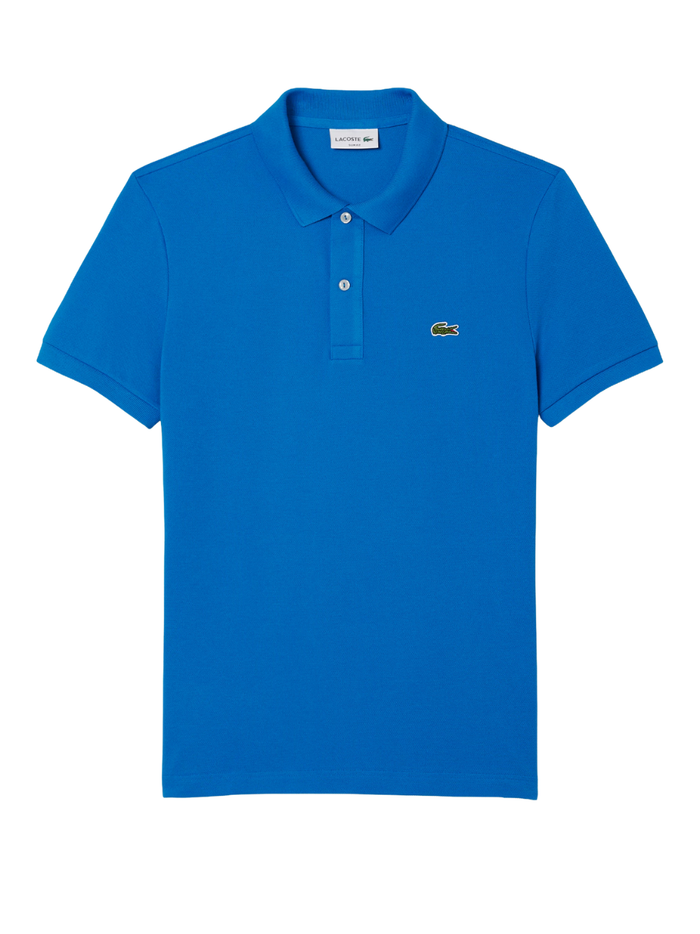 Man wearing denim blue LACOSTE L.12.12 slim fit piqué polo shirt with signature green crocodile logo and two-button placket