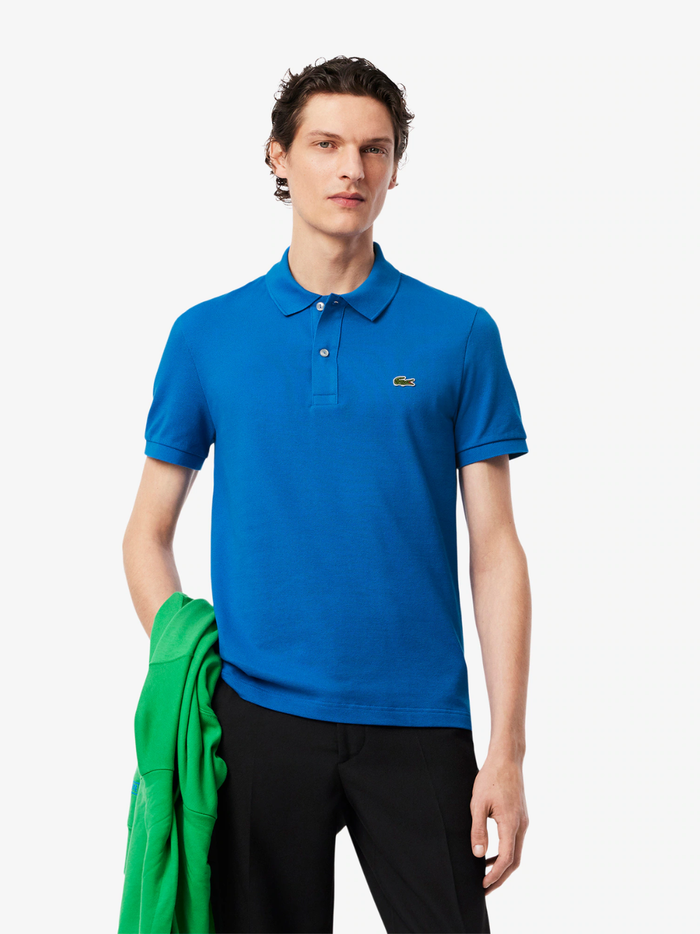 Back view of LACOSTE denim blue slim fit polo shirt showing classic piqué cotton texture and tailored fit