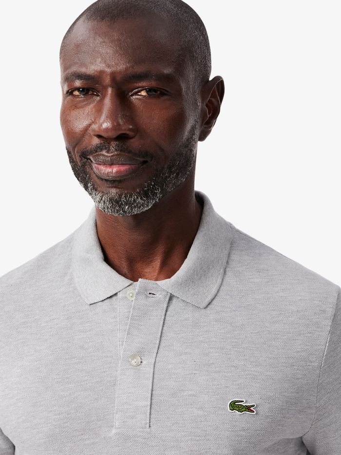 Side profile of LACOSTE L.12.12 grey polo shirt highlighting slim fit cut and ribbed collar detail