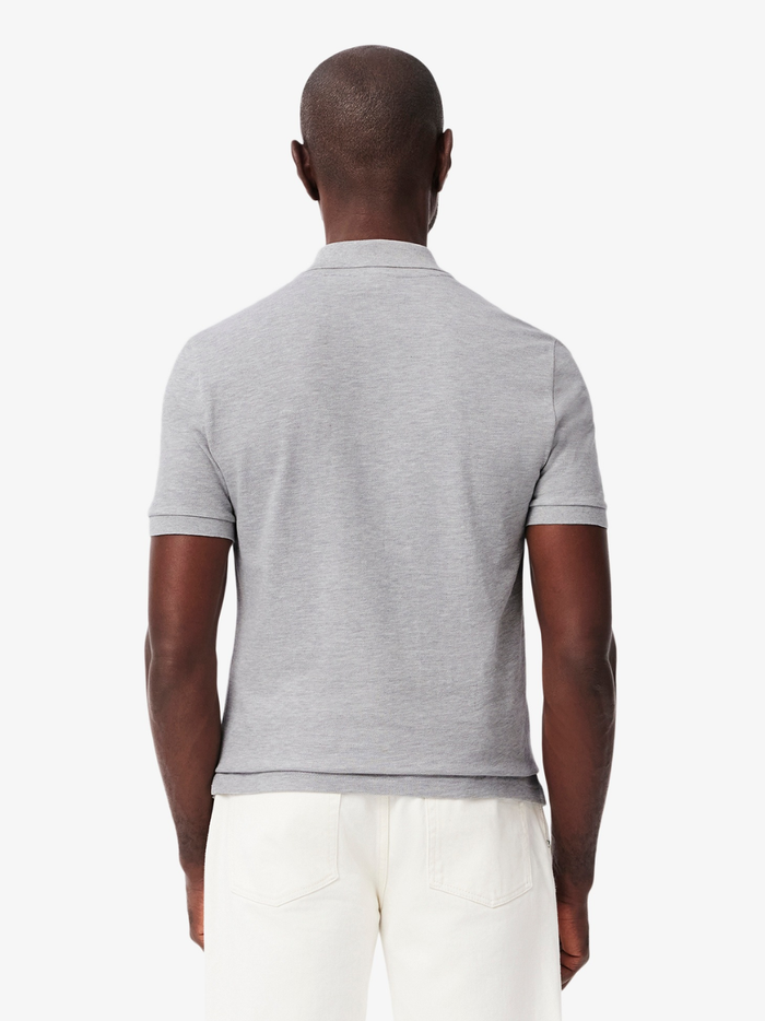 Close-up of LACOSTE polo shirt ribbed collar, mother-of-pearl buttons, and premium piqué fabric weave in grey