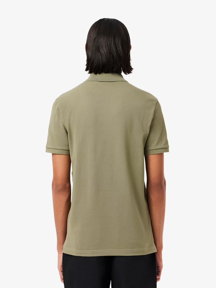 Detail shot of iconic LACOSTE green crocodile embroidery on khaki green L.12.12 piqué polo shirt chest