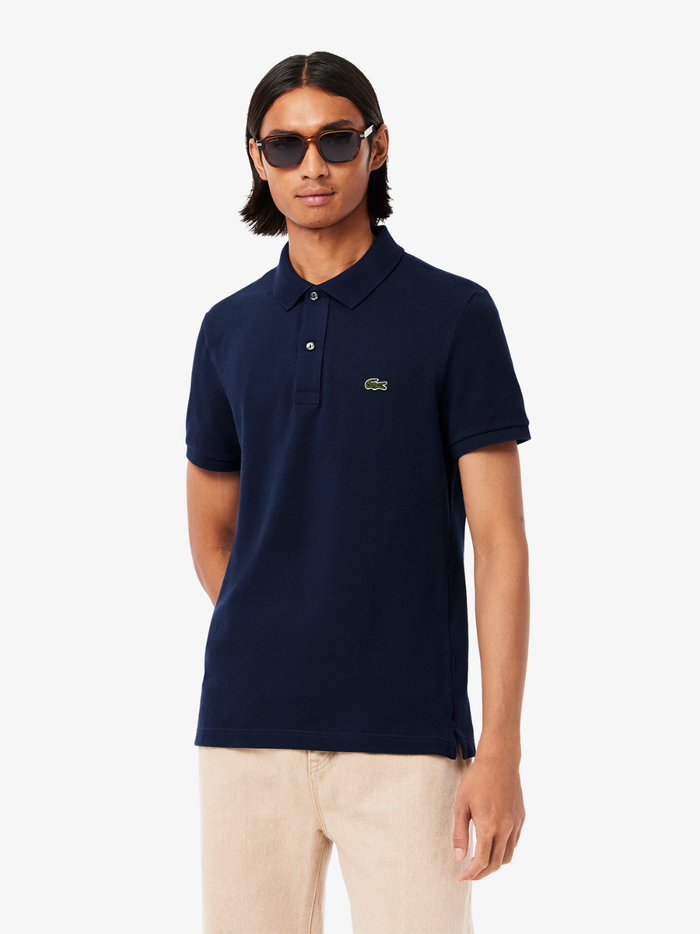 Back view of LACOSTE midnight blue slim fit polo shirt showing classic piqué cotton texture and tailored fit