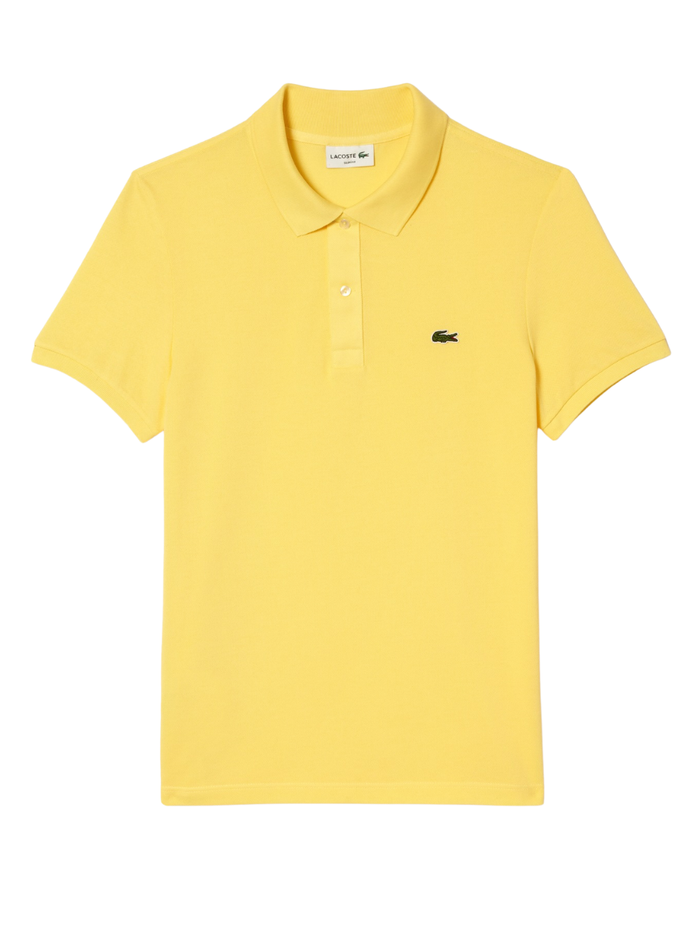 Man wearing pastel yellow LACOSTE L.12.12 slim fit piqué polo shirt with signature green crocodile logo and two-button placket