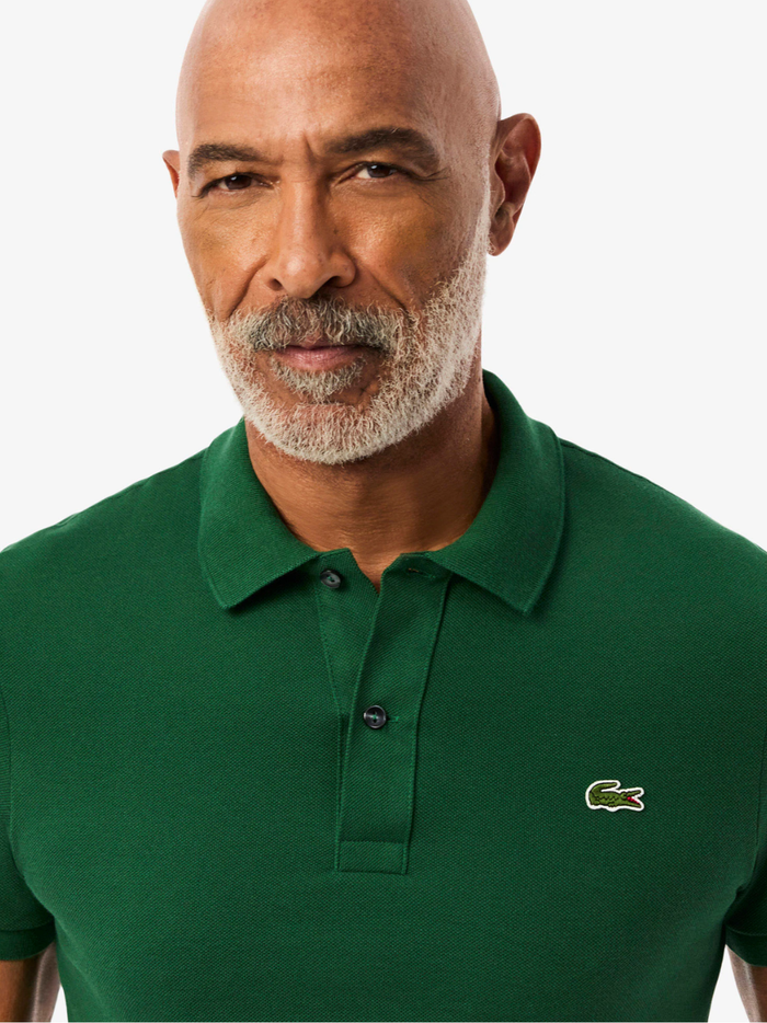 Side profile of LACOSTE L.12.12 pine green polo shirt highlighting slim fit cut and ribbed collar detail
