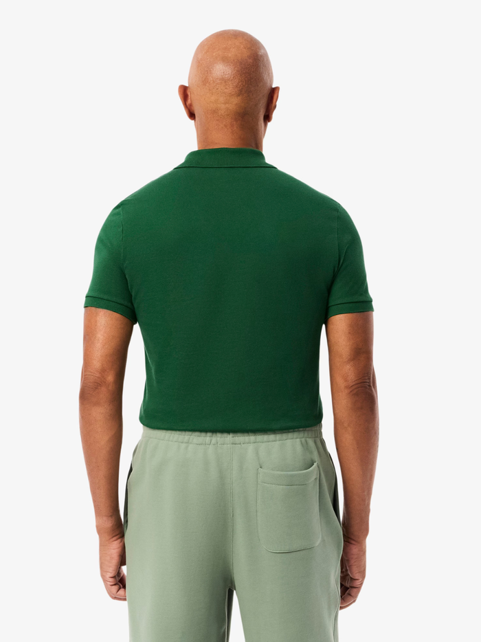 Close-up of LACOSTE polo shirt ribbed collar, mother-of-pearl buttons, and premium piqué fabric weave in pine green