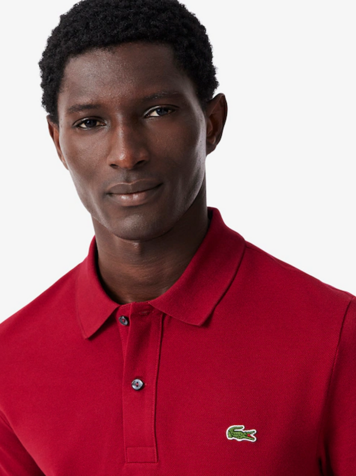 LACOSTE Slim Fit L.12.12 Piqué Polo Shirt Red - close-up detail of embroidered crocodile logo and piqué fabric texture