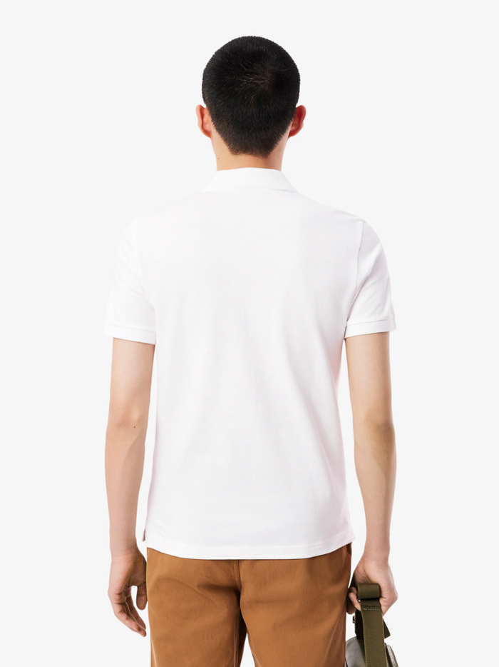 Close-up of LACOSTE polo shirt ribbed collar, mother-of-pearl buttons, and premium piqué fabric weave