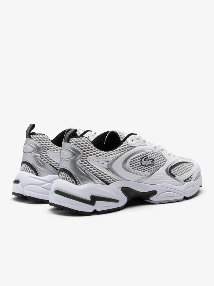 Overhead view of LACOSTE Storm 96 2K white trainers featuring breathable mesh construction, synthetic overlays, tonal laces, and embroidered green crocodile logo