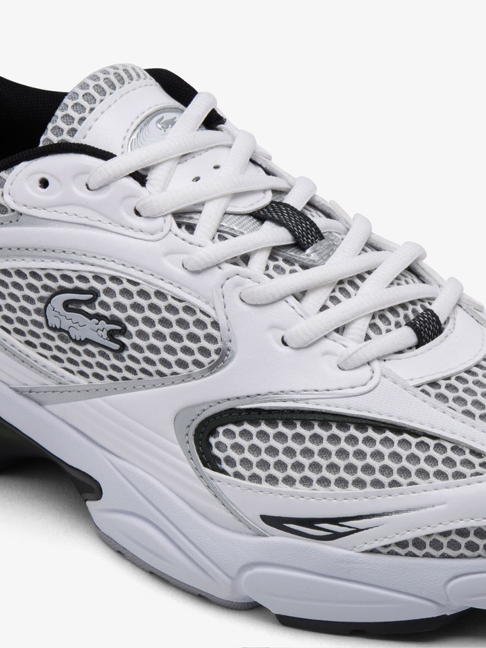 Front view of LACOSTE Storm 96 2K white chunky sneakers showing rounded toe box, layered paneling, and vintage-inspired dad shoe silhouette