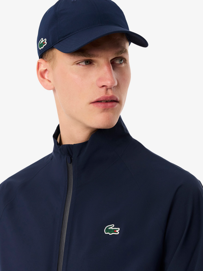 LACOSTE Water-Repellent Golf Stretch Windbreaker in navy - side view highlighting the stretch mobility and functional golf design