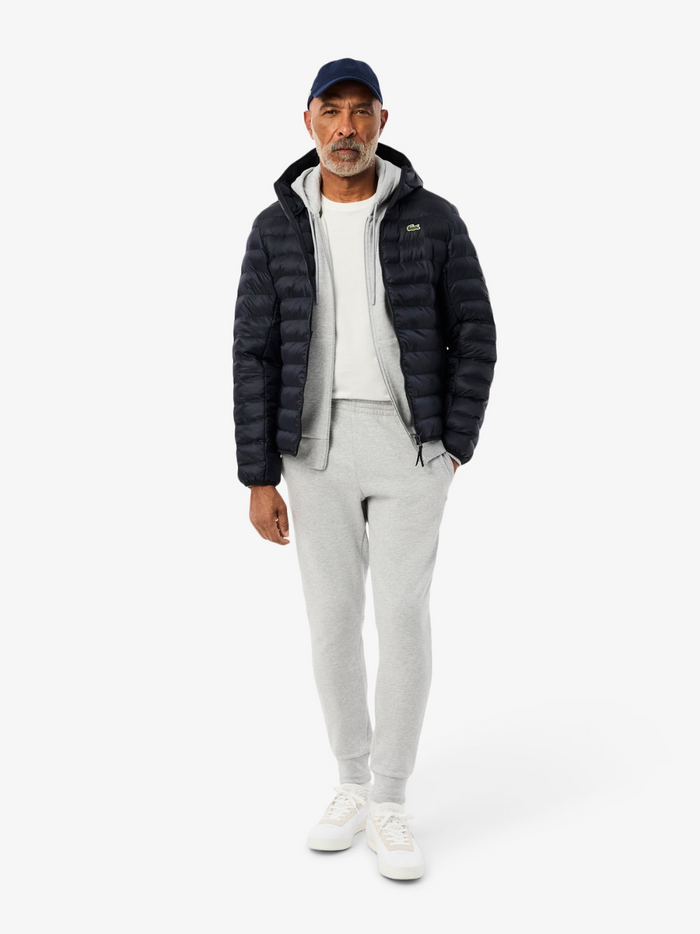 Close-up detail of LACOSTE Water-Repellent Quilted Puffed Jacket showing navy quilted fabric texture, water-repellent finish and quality stitching