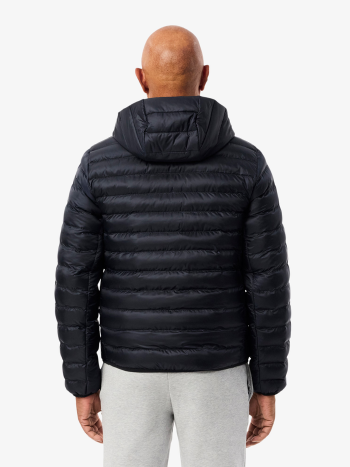 LACOSTE Water-Repellent Quilted Puffed Jacket chest and collar detail featuring the iconic LACOSTE crocodile logo on navy quilted fabric