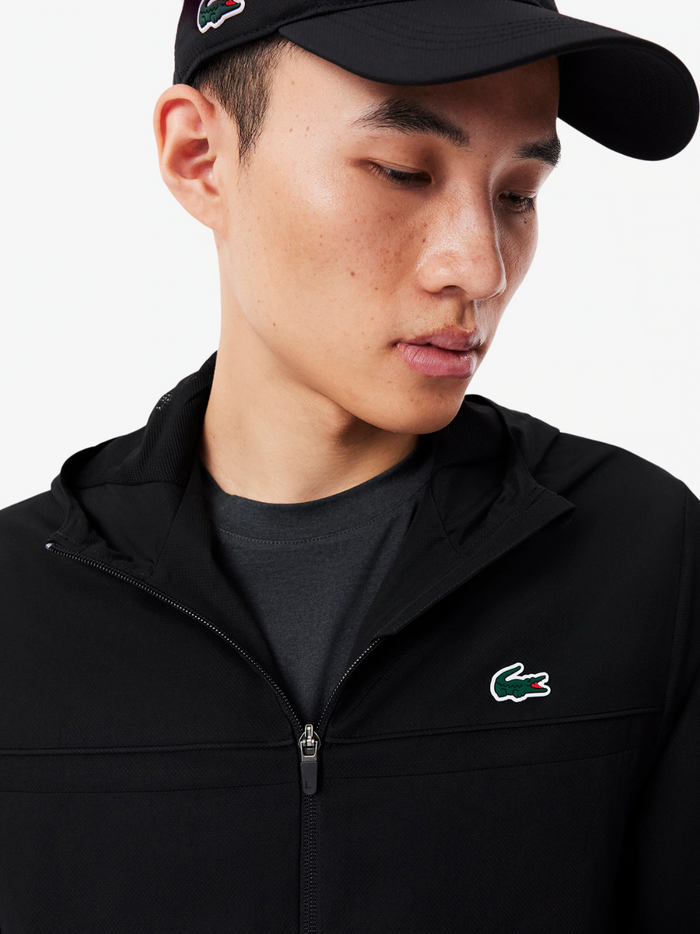 LACOSTE Sport Track Jacket Black - Close-up detail of embroidered crocodile logo and water-repellent fabric texture
