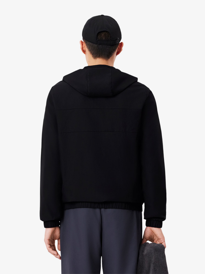 LACOSTE Black Water-Repellent Jacket - Flat lay styling shot highlighting overall athletic design and proportions